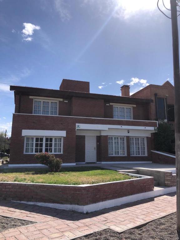 a large brick house with a driveway in front of it at House beach in Puerto Madryn