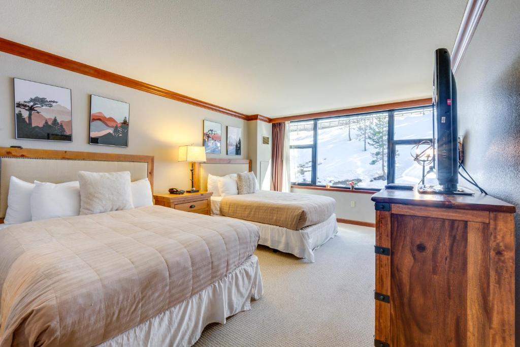 a hotel room with two beds and a flat screen tv at Olympic Valley Summer Sanctuary in Everline Resort in Olympic Valley