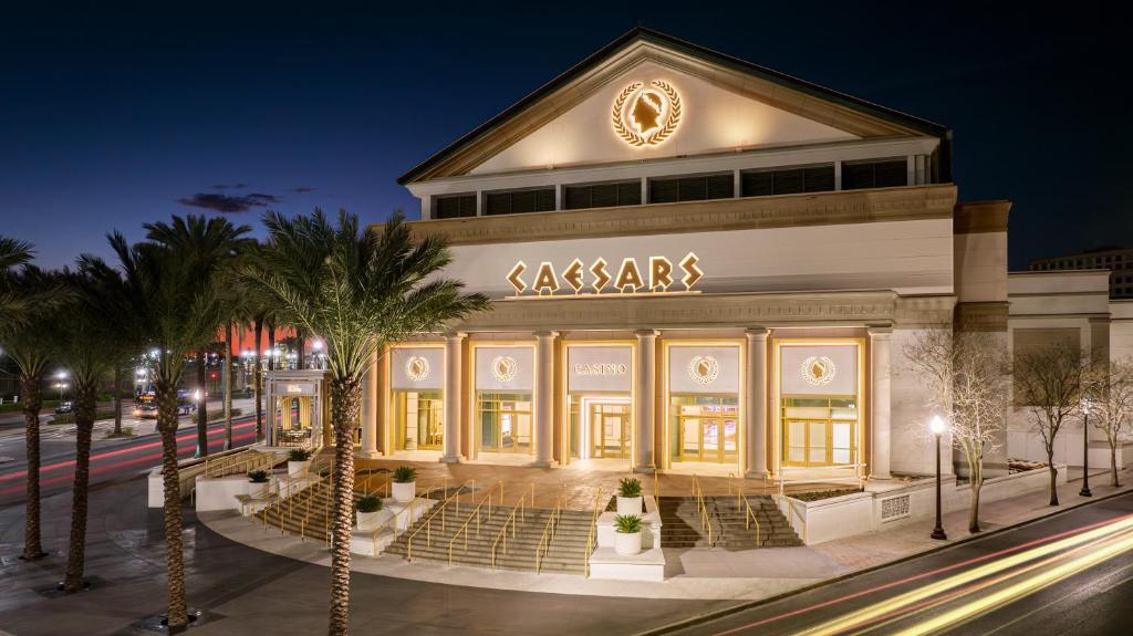 a store front at night with palm trees in front at Caesars New Orleans, A Caesars Rewards Destination in New Orleans