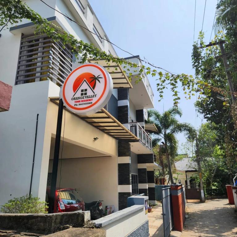 a sign that is on the side of a building at Orange valley Town Residency in Trivandrum