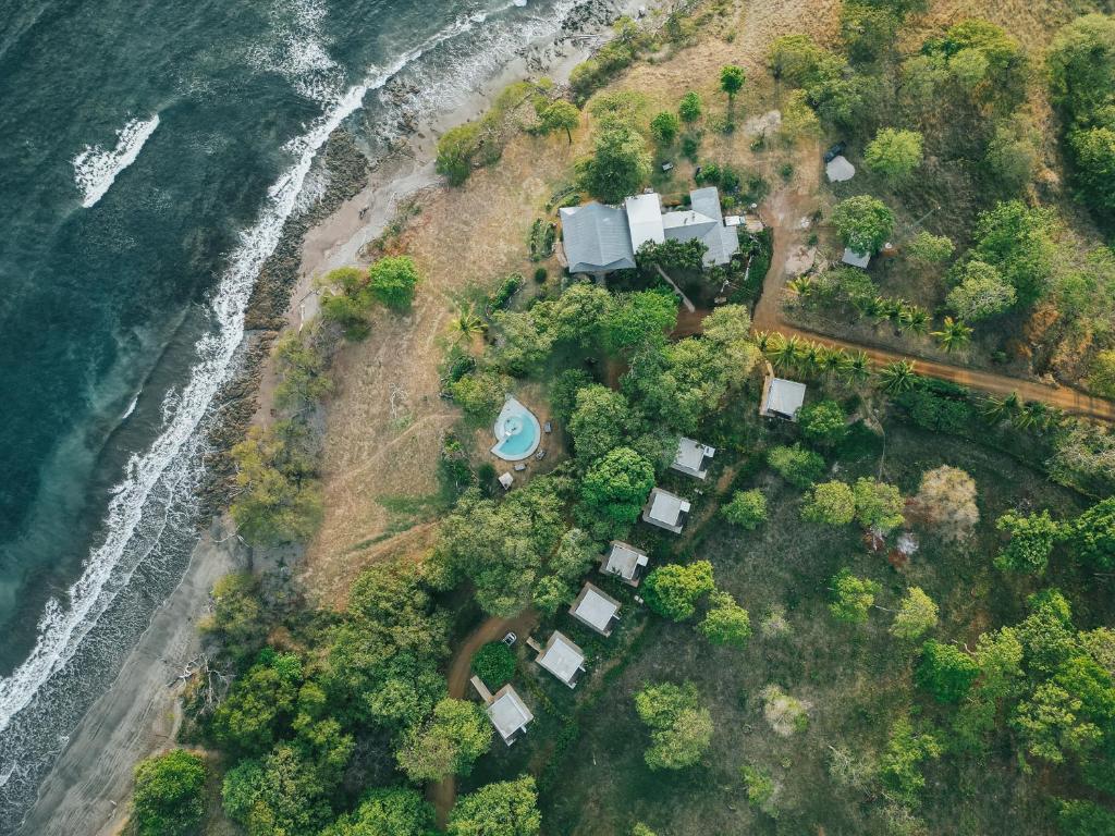 an aerial view of a house next to the ocean at Hotel Bohemian Lagarto in Santa Cruz