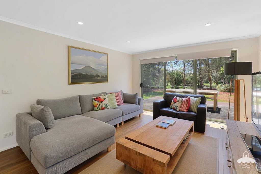 a living room with two couches and a coffee table at The Ash, Sandy Point Stay 3 Pay 2 Winter Special in Sandy Point
