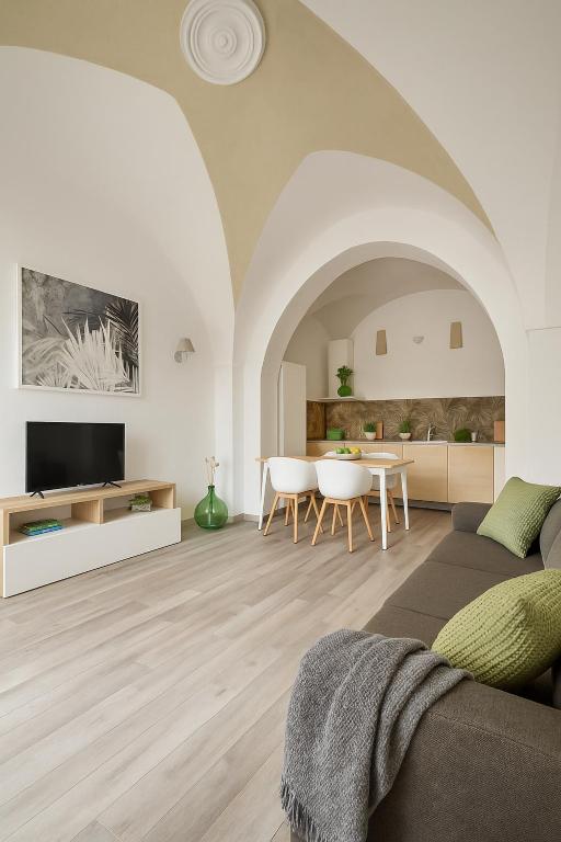 a living room with a couch and a table at leuca house in Lecce