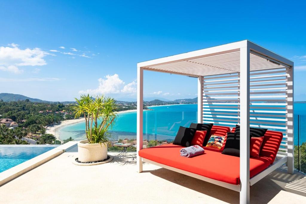 a gazebo on a balcony with a view of the ocean at STK Villa Samui Paradise Awaits in Nathon Bay