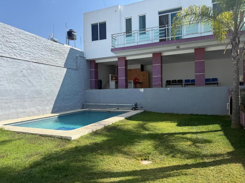 a house with a swimming pool in front of it at 20 minutes from Chapala, Pool &Grill in Buenavista
