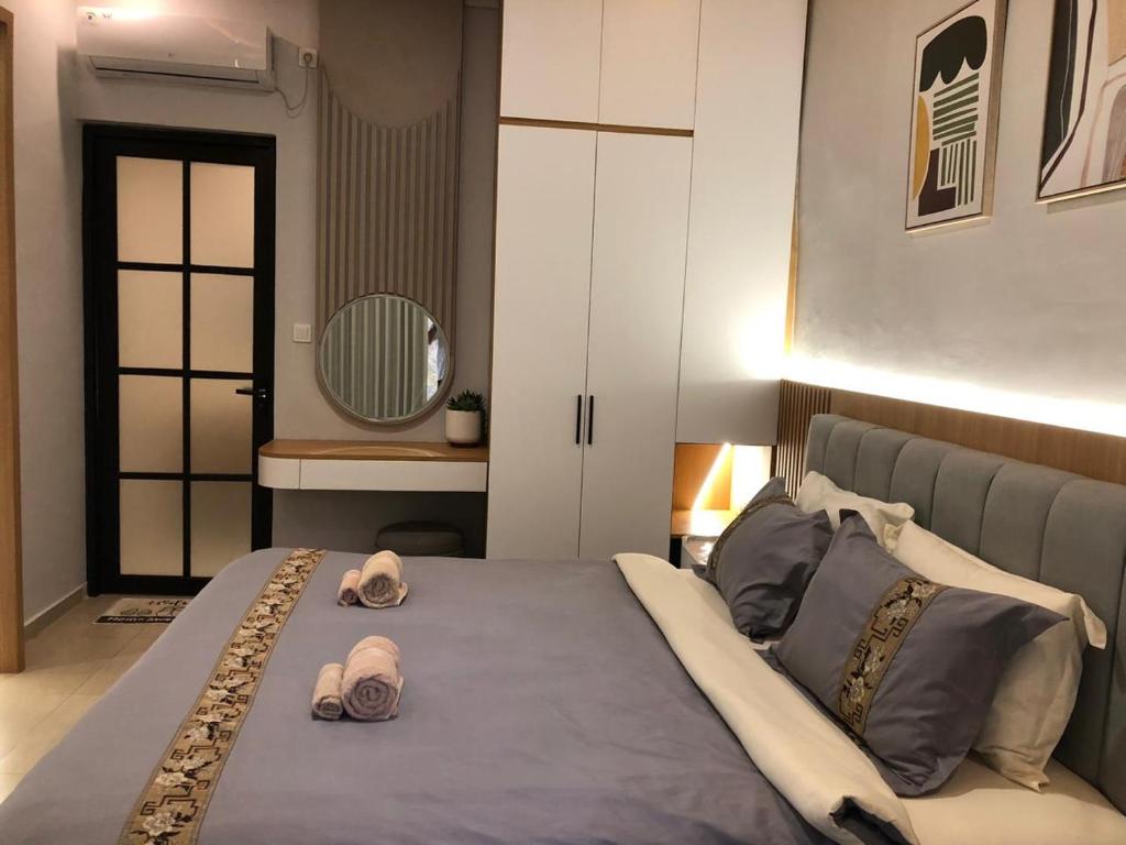 a bedroom with a large bed with towels on it at Light Star Villa in Kuta Lombok