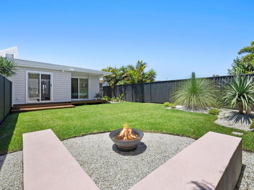 a fire pit in the yard of a house at The Eddy Escape in Kingscliff