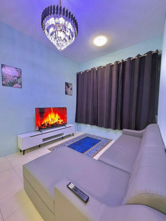 a living room with a couch and a fireplace at Aileen Homestay in Tawau