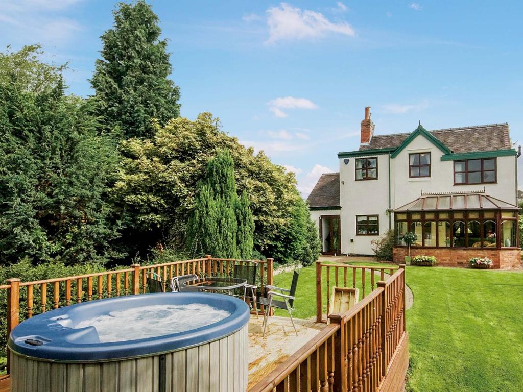 a hot tub in the backyard of a house at Bridge House in Overseal