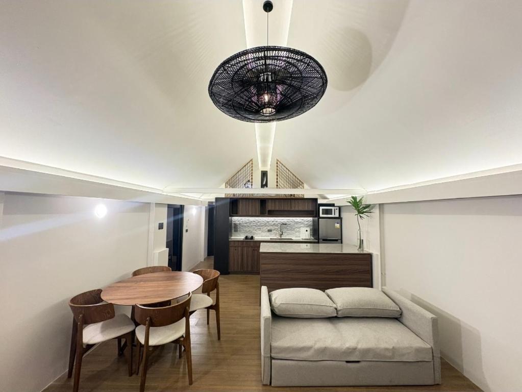 a living room with a table and a couch at Elev Ph - Staycation Penthouse in San Nicolas