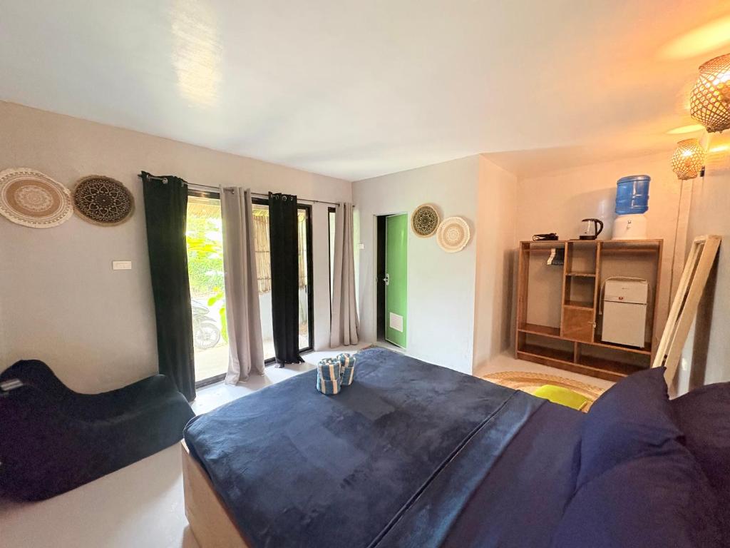 a living room with a table and a kitchen at Jaydy Guest House in General Luna