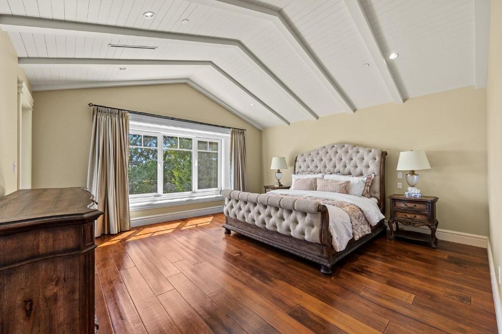 a bedroom with a large bed and a large window at Spacious Cozy House in Vancouver West in Vancouver