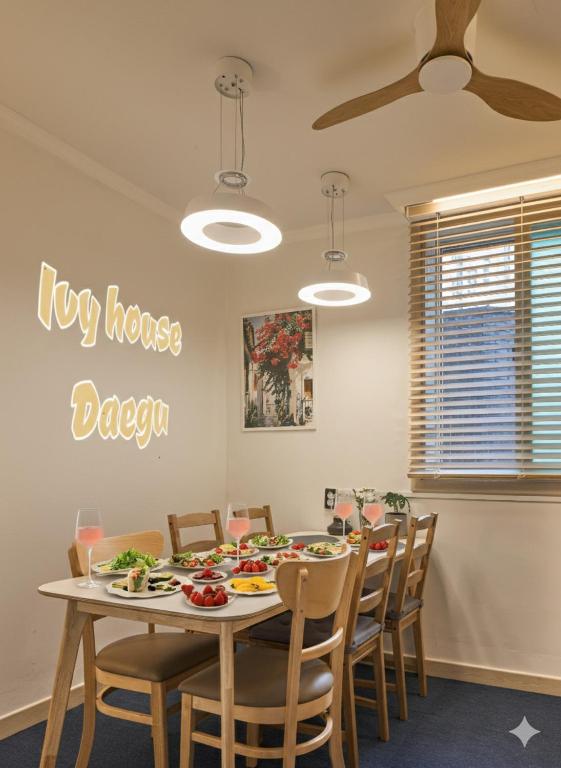 a dining room with a big house dozen sign on the wall at Banwoldang Stn 3min, 2F 4pm & 3F 8pm Check-in, Table for 6, Hotel bedding, Luggage Storage in Daegu