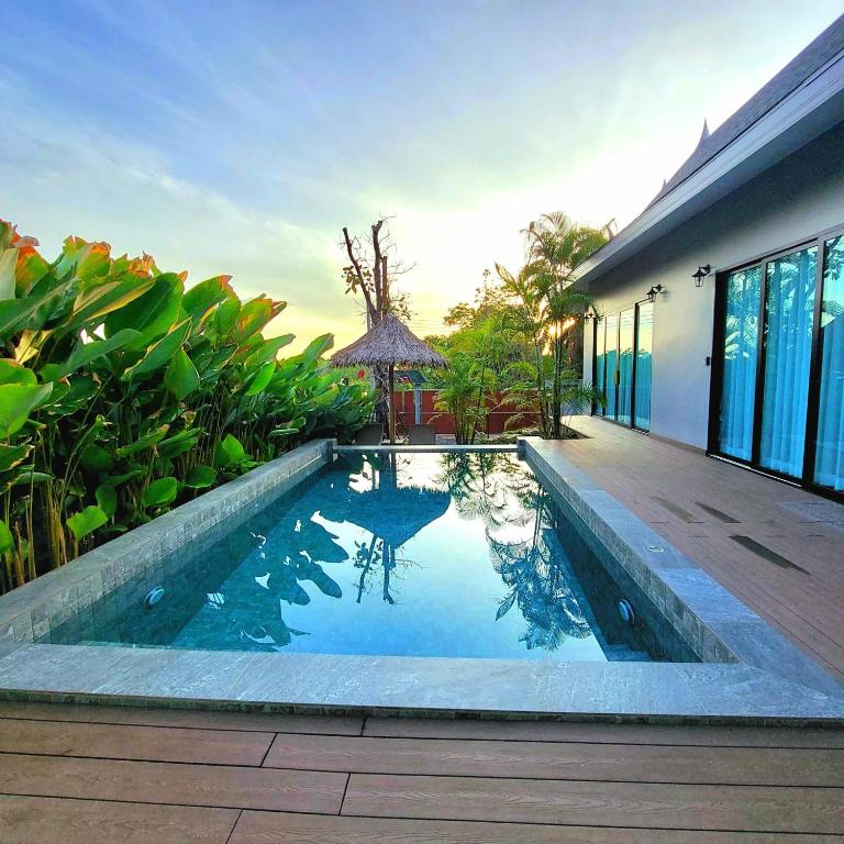 a swimming pool in front of a house at Ing Suan pool villa 1 in Ao Nang Beach