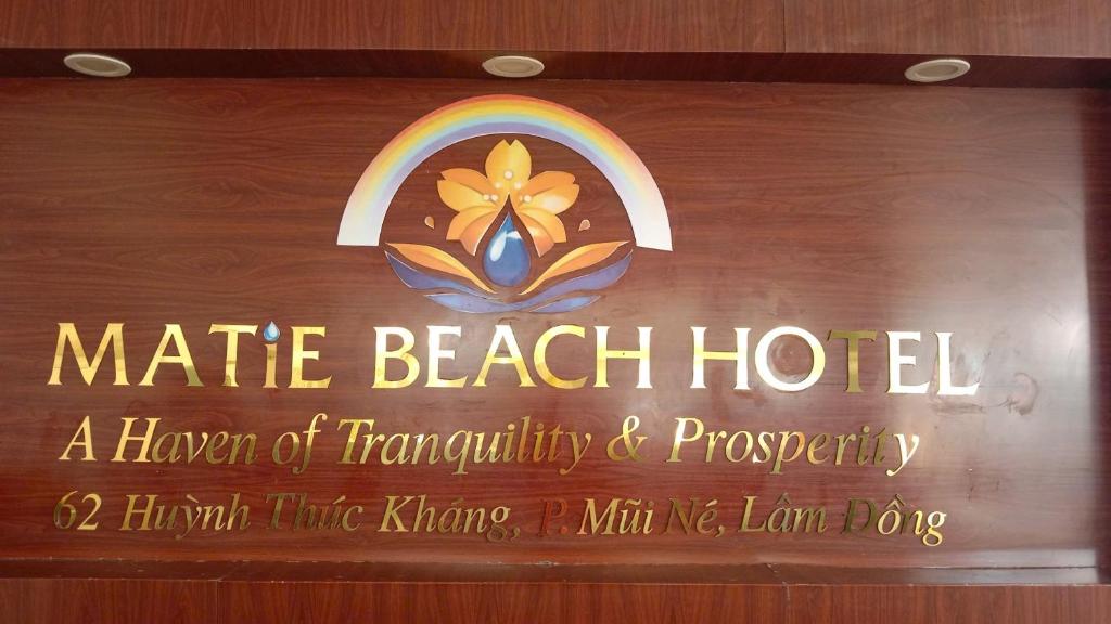 a sign that says mate beach hotel with a rainbow at Matie Beach Hotel & Resort in Kao Kuil
