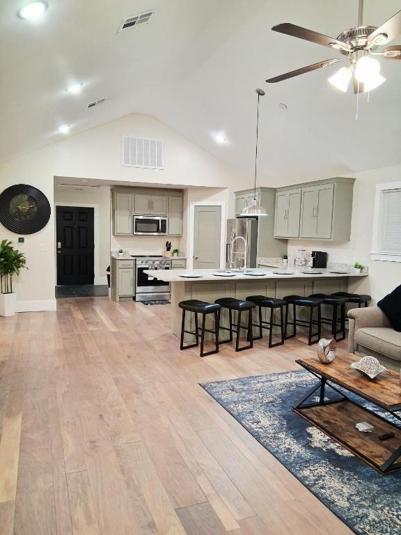 a kitchen and living room with a couch and a table at Xscapecatio Oasis II in Tulsa