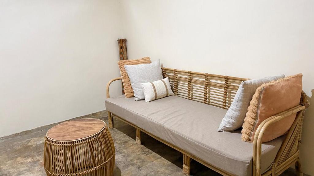 a bench with pillows on it in a room at Ayu Homestay - Room 4 in San Isidro