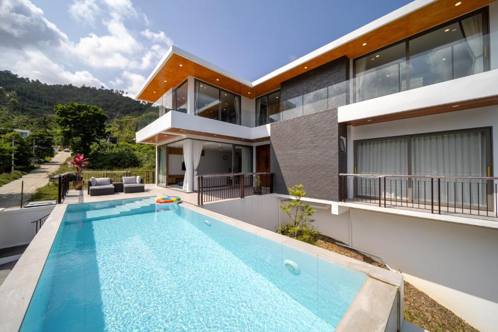 an exterior view of a house with a swimming pool at Villa M3 De Samui in Nathon Bay