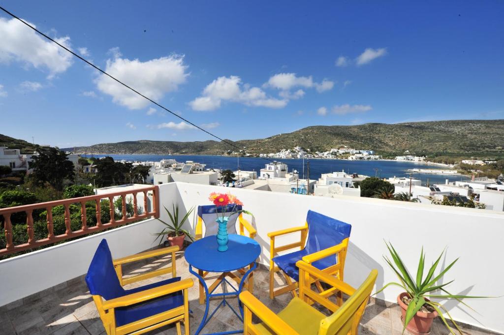 a balcony with chairs and a table with a view at Pension Sofia Amorgos-Katapola in Katapola