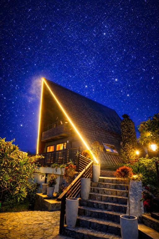 a building with stairs under a starry sky at Kubana in Nuwara Eliya