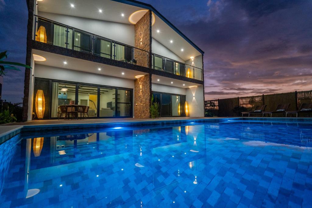 a large swimming pool in front of a house at Tides Apartments in Nadi