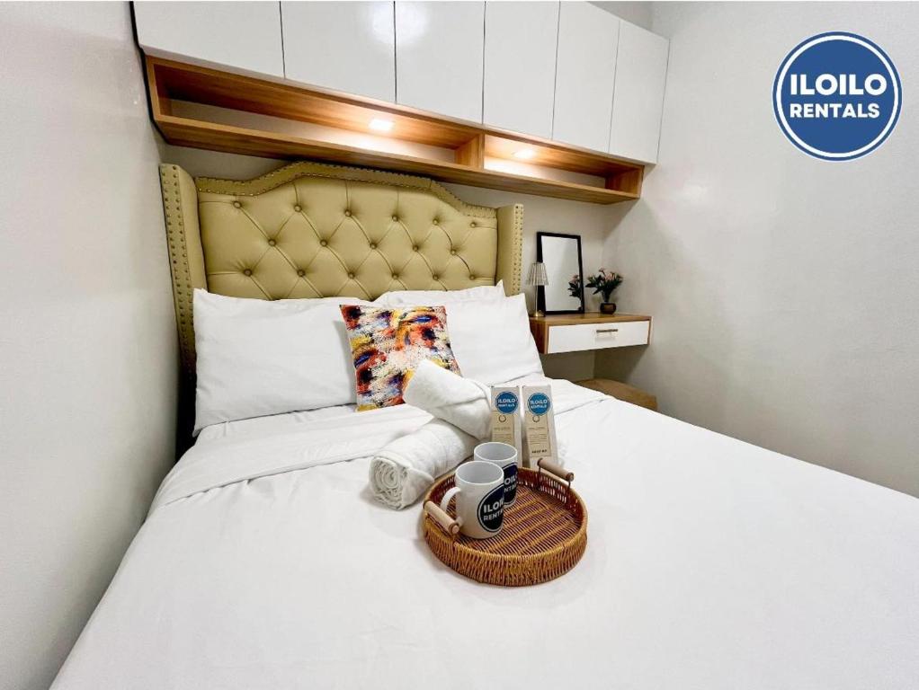 a hotel room with a bed with a basket on it at Modern Style 2-BR in SMDC in Iloilo City