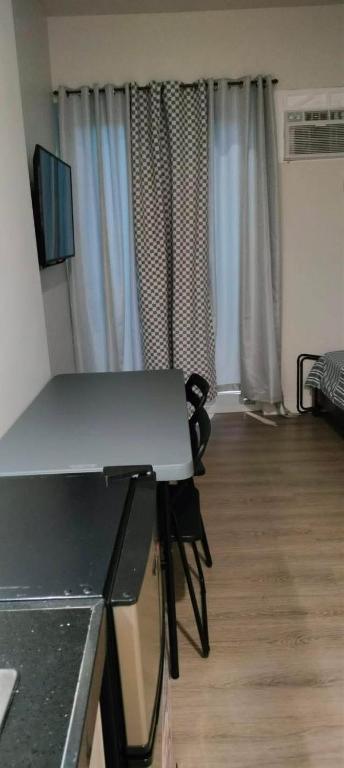 a room with a kitchen and a living room at Wide studio Antara Residences Talisay in Talisay