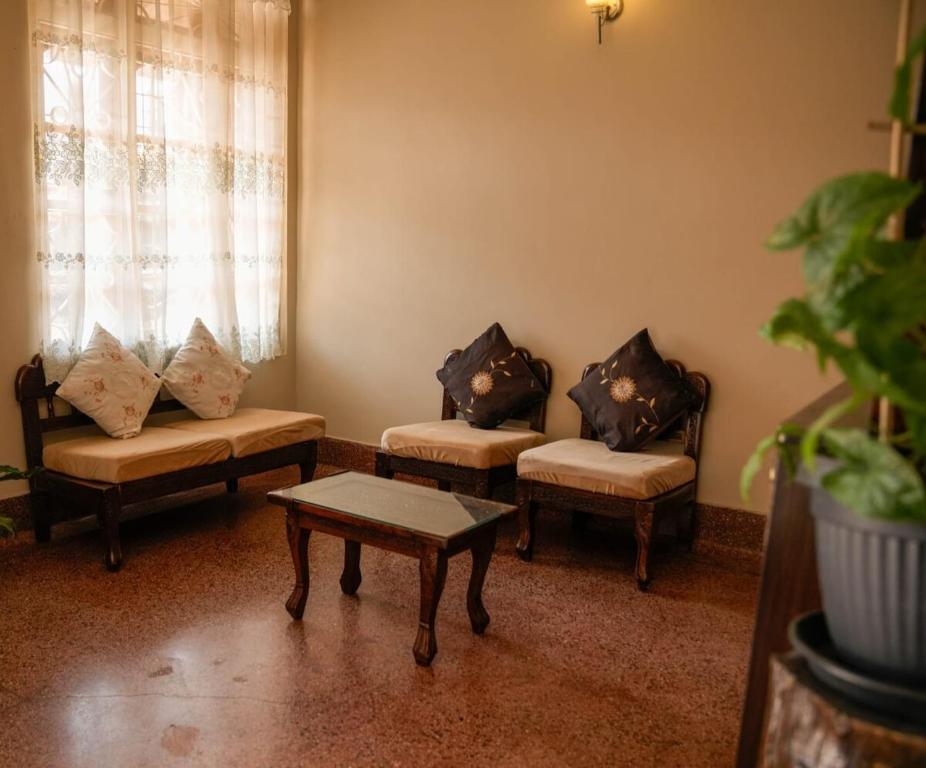 a living room with two couches and a coffee table at Meizies Home in Shillong