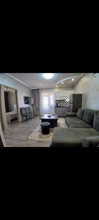 a living room with a couch and a table at Tom House Garden in Tsaghkadzor