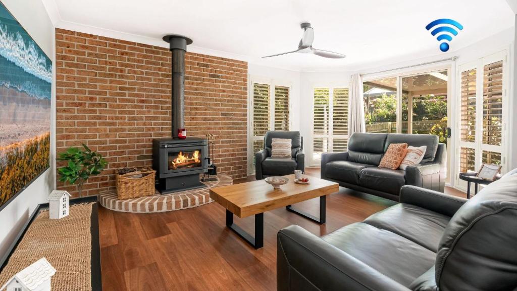 a living room with a brick wall and a fireplace at La Playa in Myola