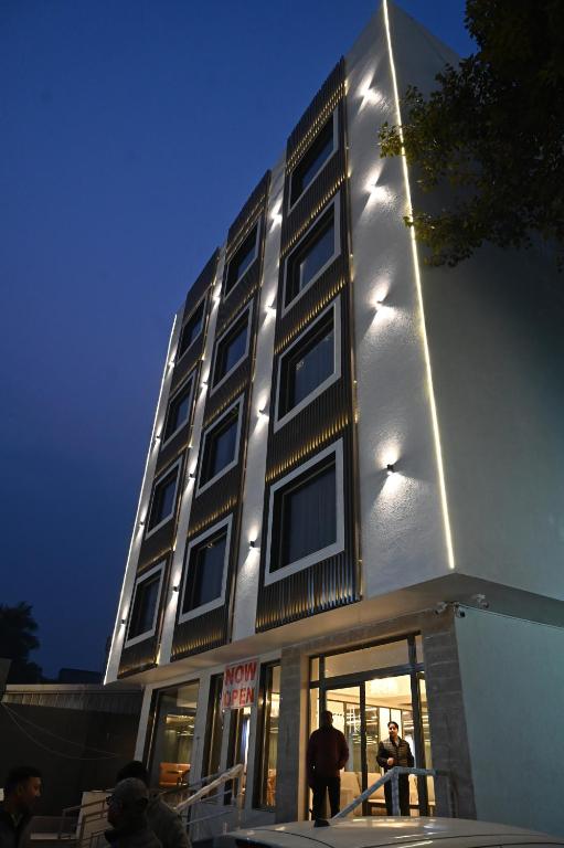 a building with people standing in front of it at Hotel Meera Palace in Varanasi