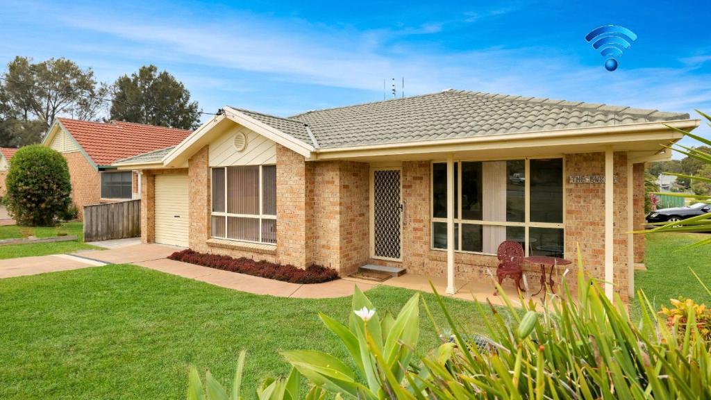 a house with a hot air balloon in the air at The Coastal Corner in Culburra Beach