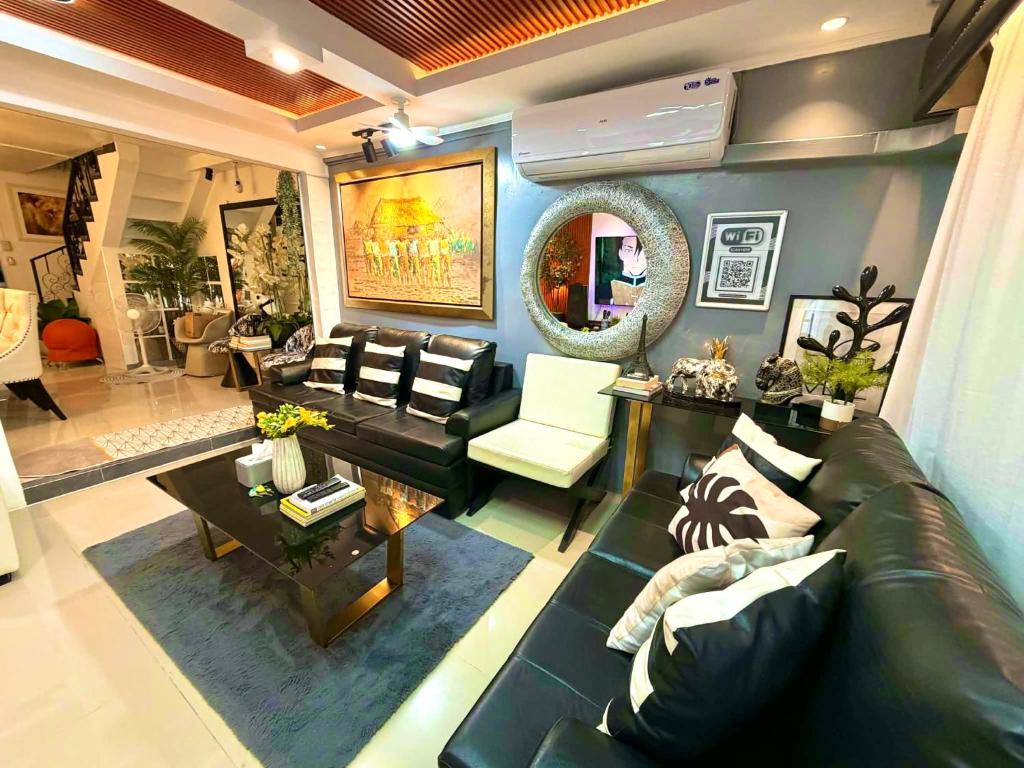 a living room with a leather couch and a table at The White Haven In Clark ENTIRE HOUSE in Angeles