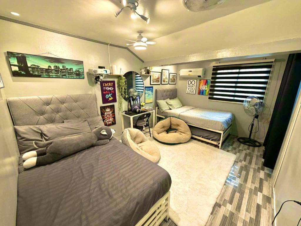 a bedroom with two beds and a room with a bed sqor at Gray Room The White Haven In Clark in Angeles