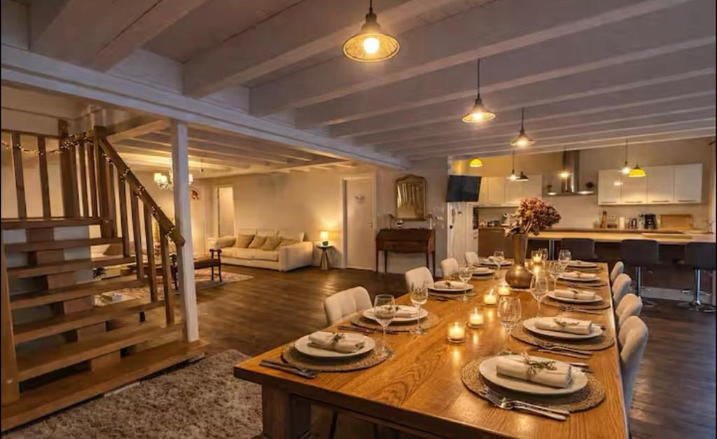 a large wooden table in a living room at Maison bonheur -Parking- piscine -espace de jeux- avec 6 suites avec SDB in Bourg-en-Bresse