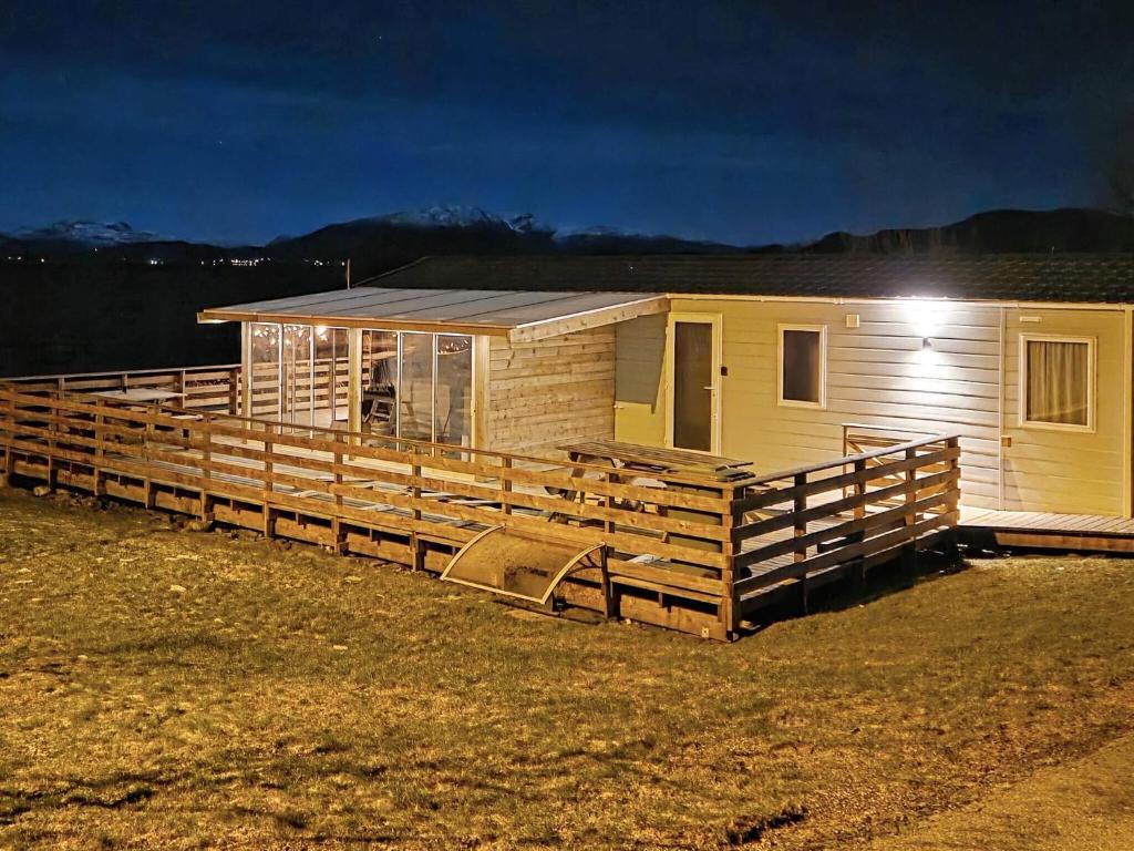 a small house with a wooden fence around it at 6 person holiday home in Tansøy-By Traum in Tansøy