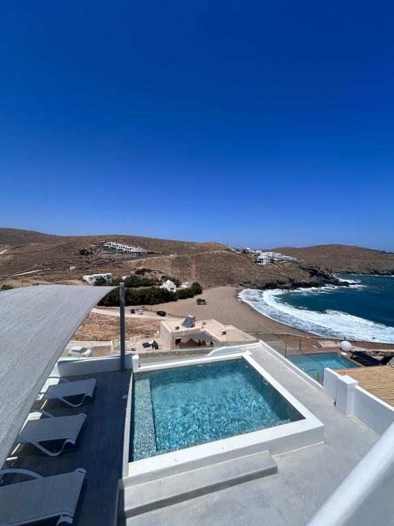 a swimming pool on the roof of a building with a beach at The Eagle Merchia Mykonos in Merchia Beach