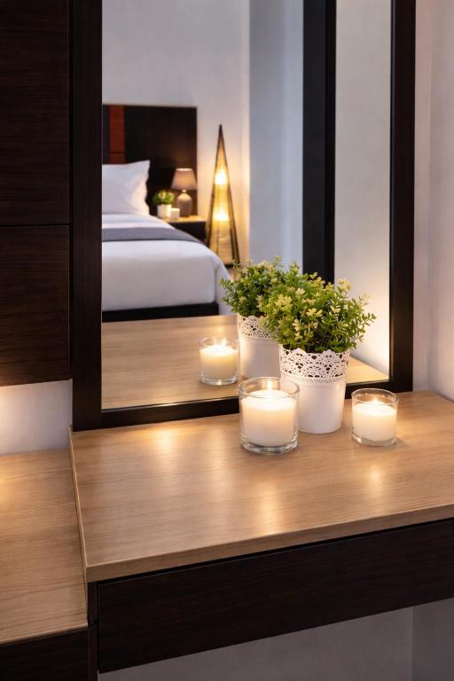 a room with a bed and candles on a table at INOH Athens Hotel in Athens