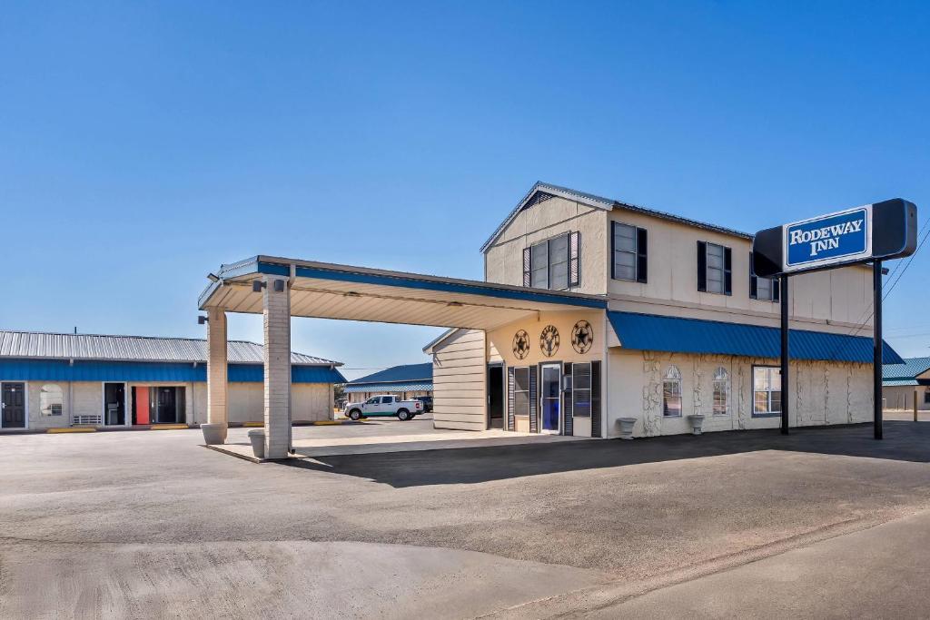 a gas station with a sign in front of it at Rodeway Inn Llano in Llano