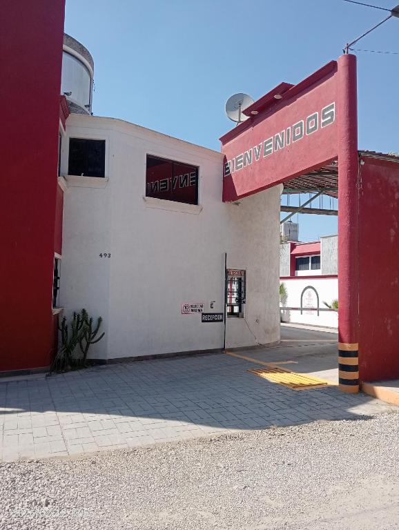a white and red building with a sign on it at Campo Real Actopan in Cedro