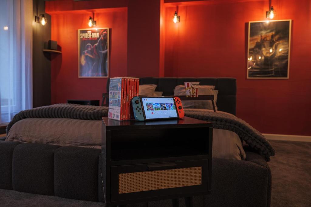 a living room with two beds and a table at CinémaRoom Béziers in Béziers