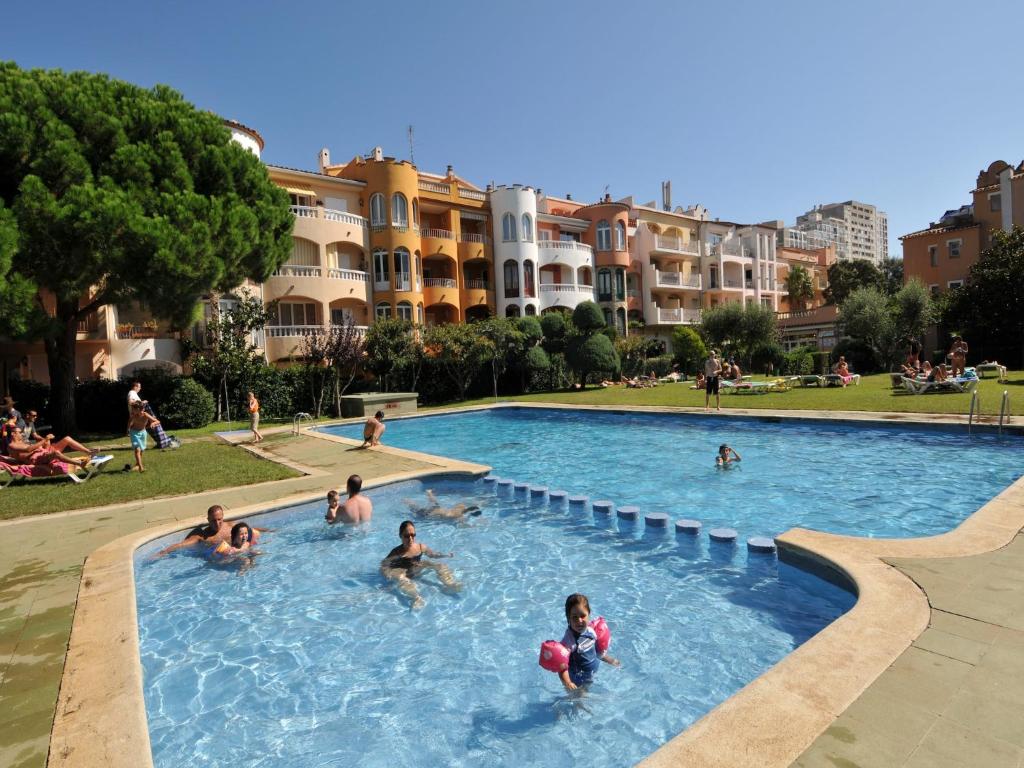 a group of people playing in a swimming pool at Apartment Empuriabrava by Beach & Canals in Empuriabrava