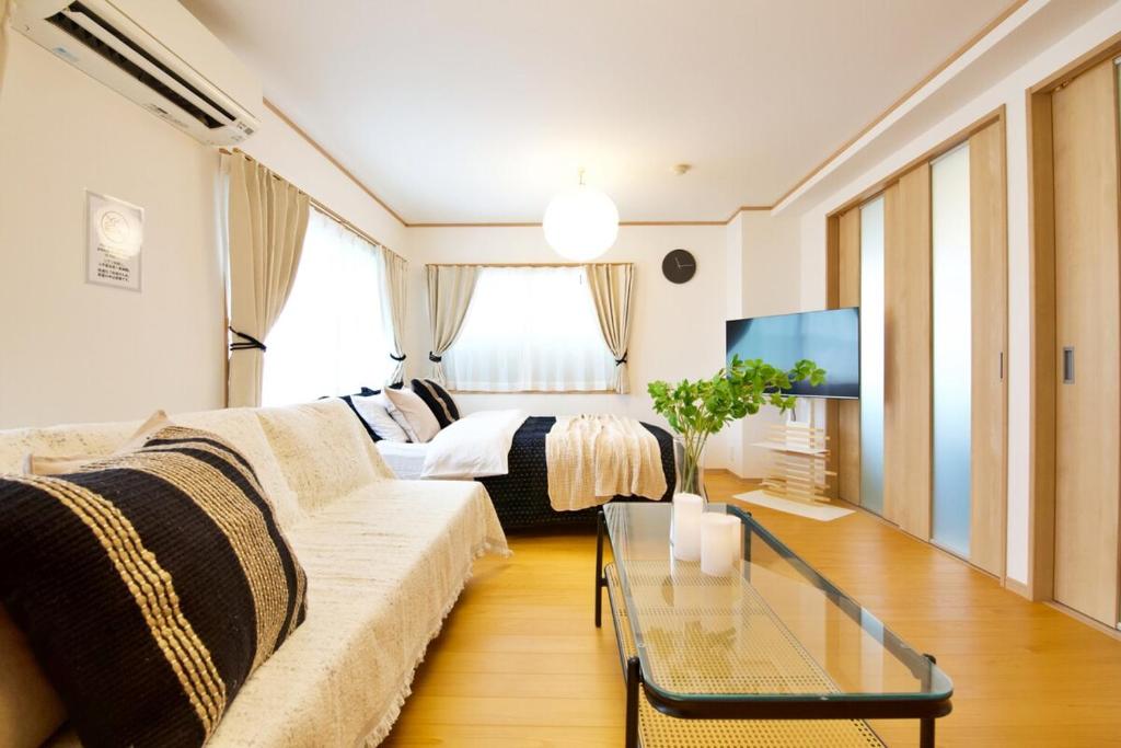 a living room with a couch and a bed at 伯旺ビル 403 in Kanazawa
