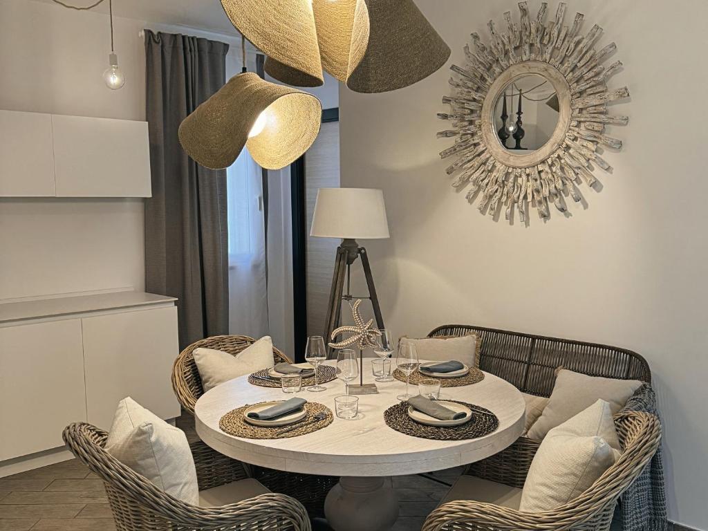 a dining room with a white table and chairs at Scirocco - Villa Marina in Marina di Andora