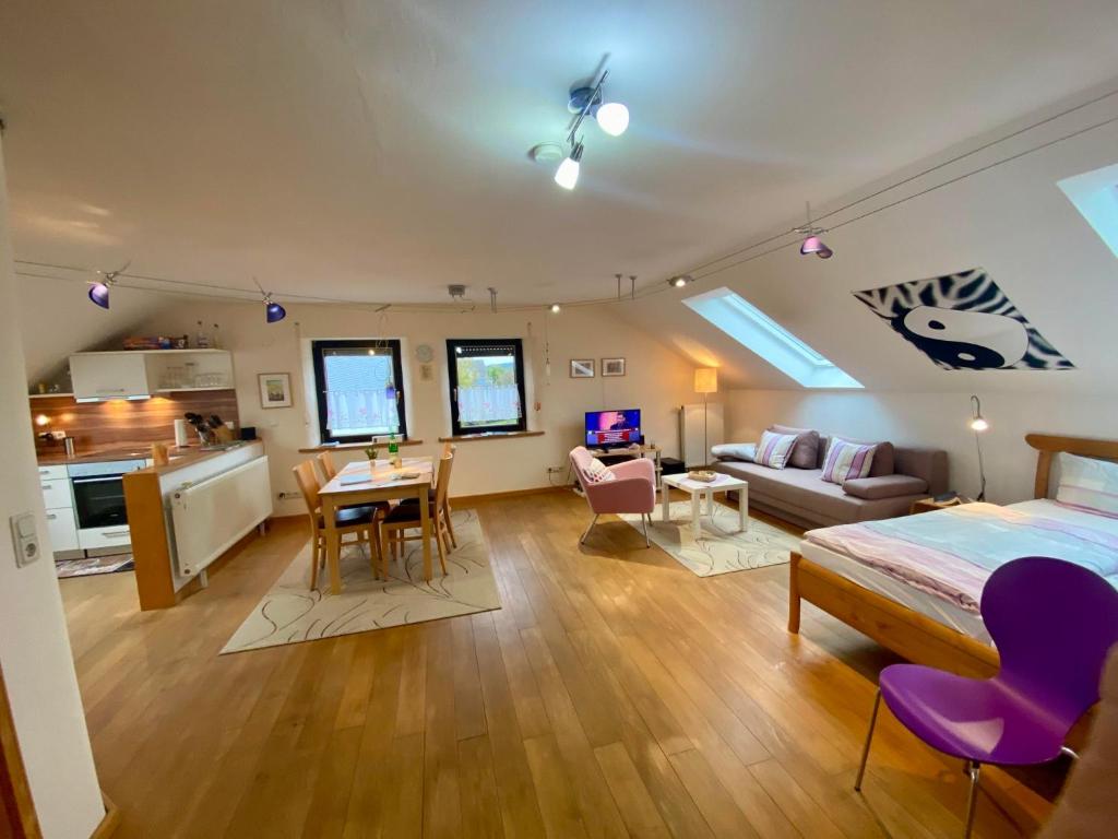 a bedroom with a bed and a living room and a kitchen at Öko-Appartement Melanie in Schwollen