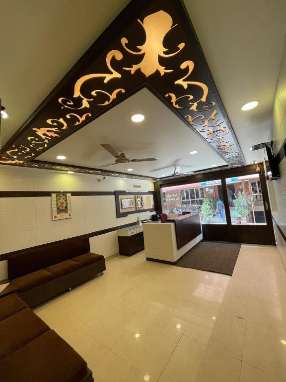 a living room with a couch and a table in a building at Manjusri Paradise in Bangalore