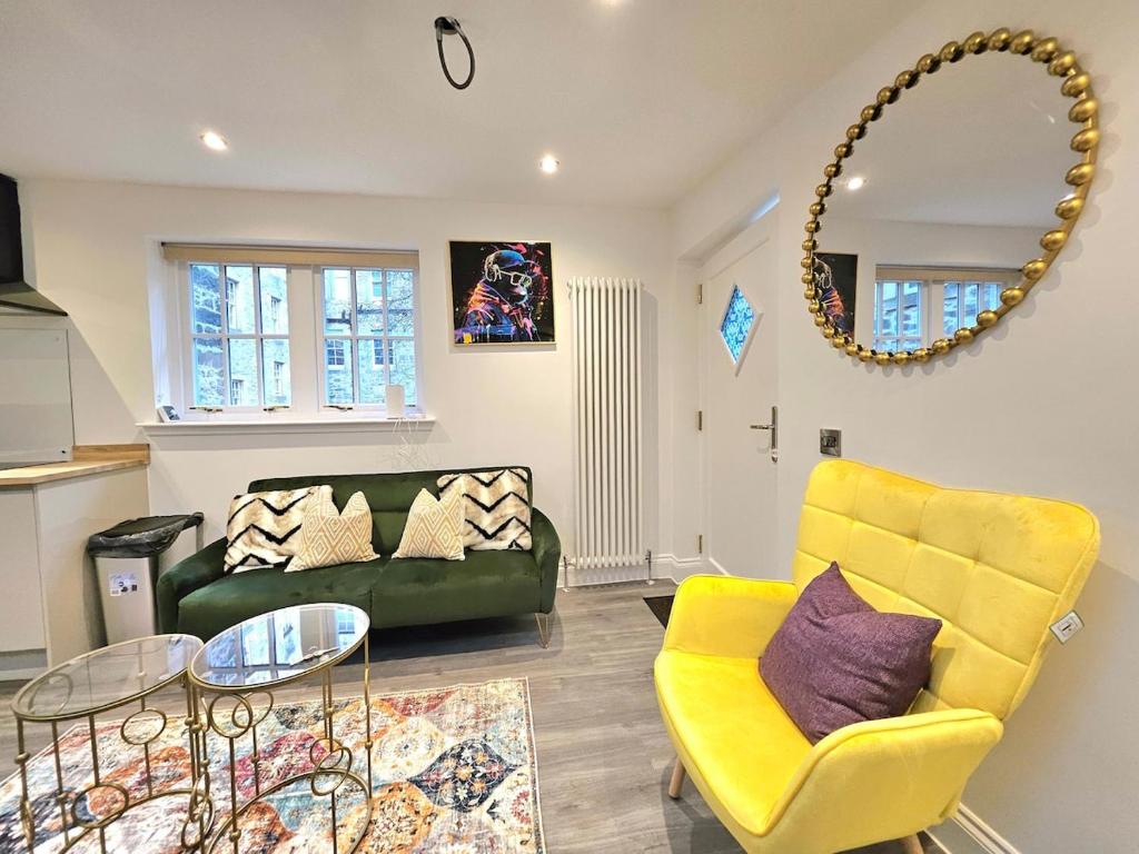 a living room with a green couch and a yellow chair at Stylish & Central Design Apartment- 3 Beds in Edinburgh