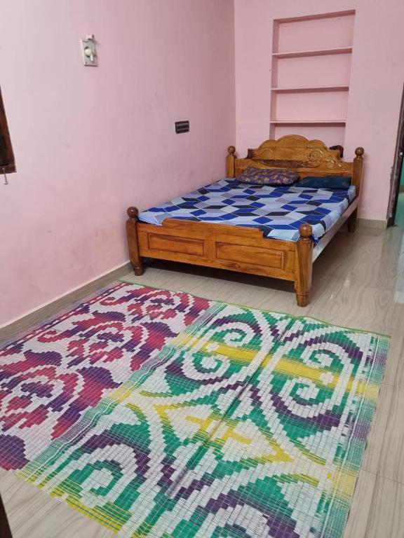 a bedroom with a bed and a rug on the floor at Vignesh Home staying in Tiruvannāmalai