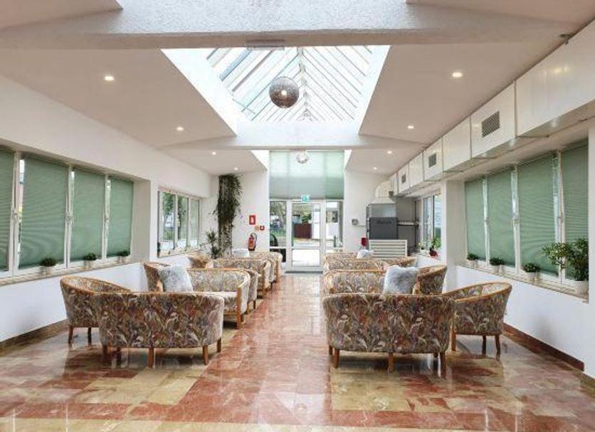 a living room with a lot of furniture and a skylight at Hotel Pause - Free WiFi & Free Parking!! in Hofheim am Taunus