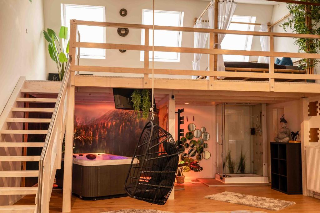 a loft bed in a room with a bath tub at Wellness Suite mit Whirlpool und Sauna in Ahlen